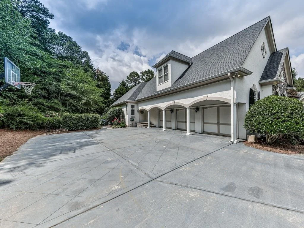 Covered back porch with outdoor stone fireplace at the Bridgemill home