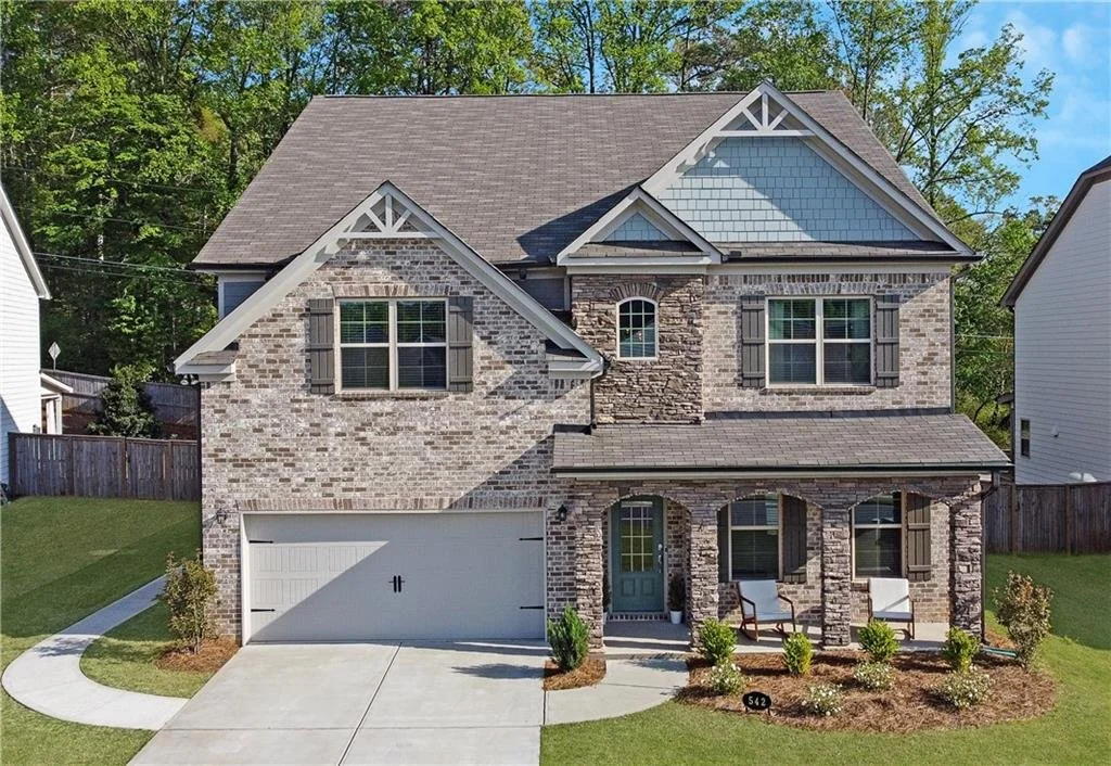A two-story brick and stone home in a gated Hickory Flat community in Canton, Georgia, recently closed by Grant Smith