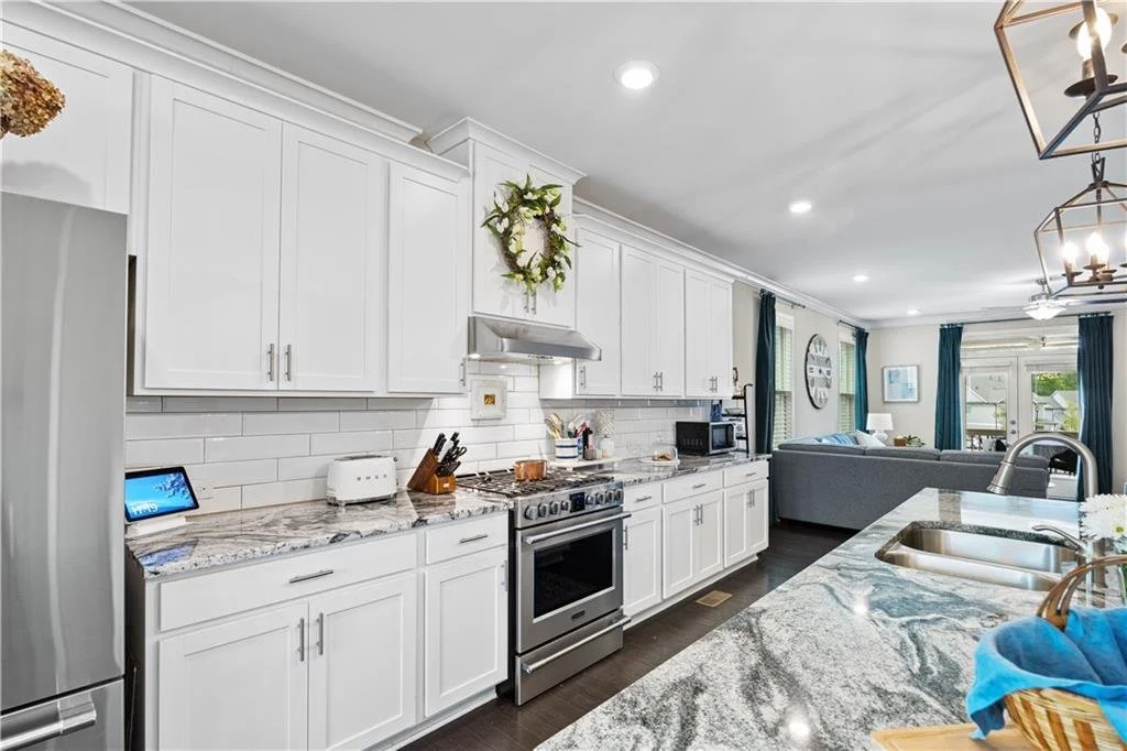 Oversized kitchen island and engineered hardwood floors at the Cumming townhome