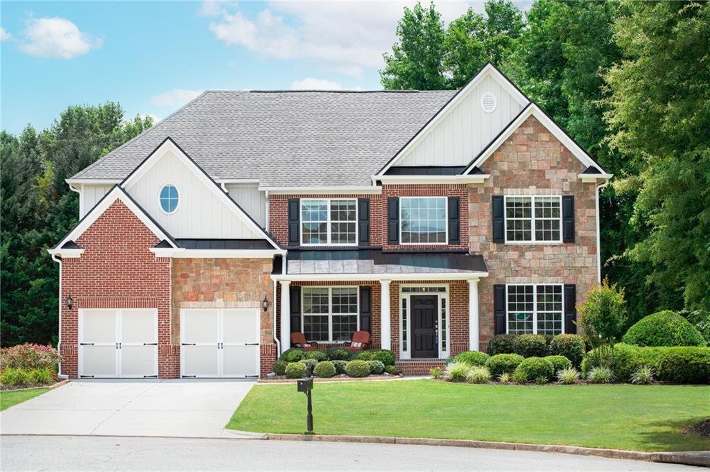 Brick and stone two-story home on a cul-de-sac lot in a Woodstock, Georgia swim and tennis community