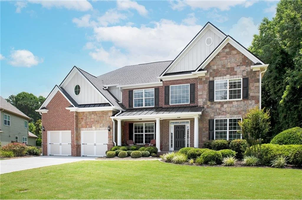 Open kitchen and living area with hardwood floors at the Woodstock home